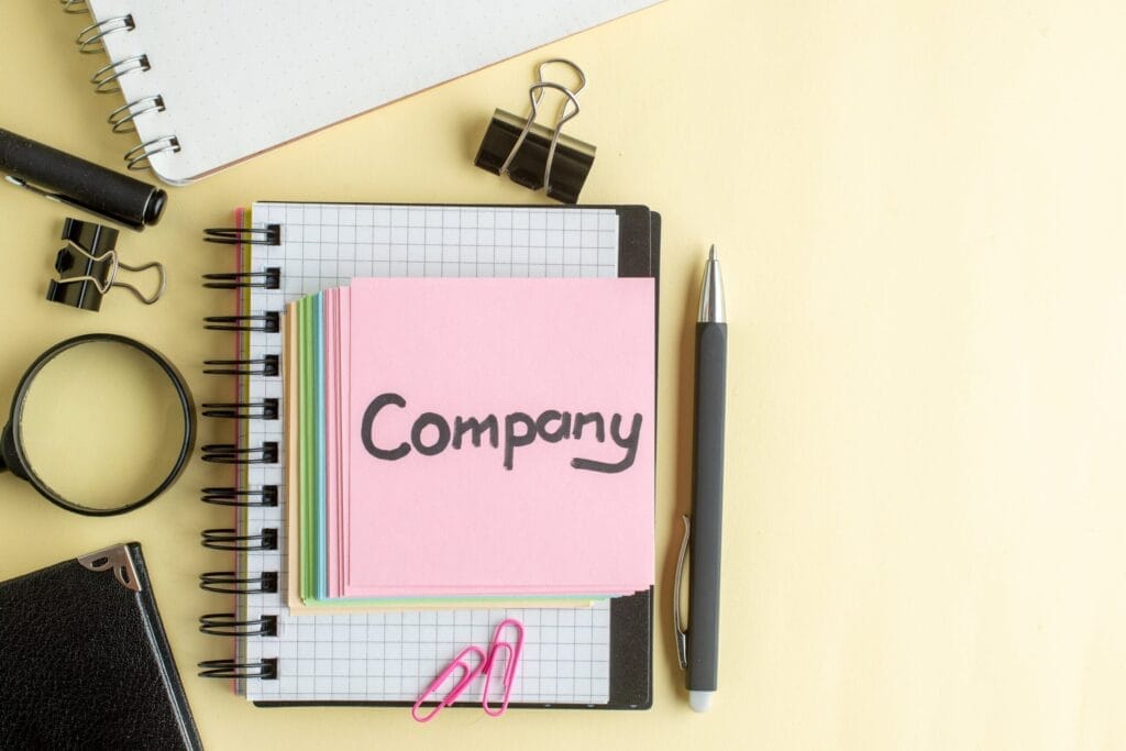 Top View Company Written Note Along With Colorful Little Paper Notes Light Surface Notepad Job Pen School Office Business Money Color Work Copybook Min Scaled 1 maximusmedia
